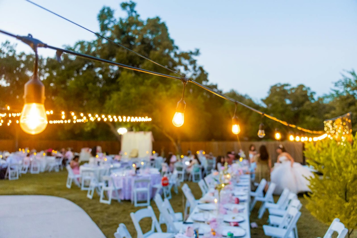 Outdoor wedding reception with warm string lights